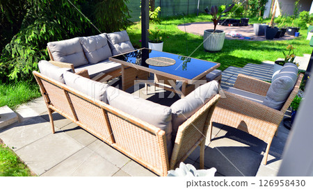 Modern aluminum pergola with stylish garden furniture in a beautiful garden. Modern aluminum pergola with stylish garden furniture in a beautiful garden. 126958430