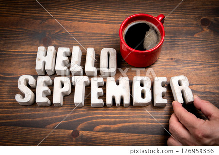 Hello September. Concrete alphabet letters and coffee mug on dark wooden texture background 126959336