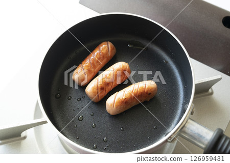 wieners baked in a frying pan 126959481