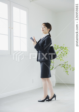 Woman operating a smartphone Woman operating a smartphone 126959881
