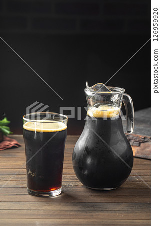 Glass and jug of russian bread drink kvass Glass and jug of russian bread drink kvass 126959920