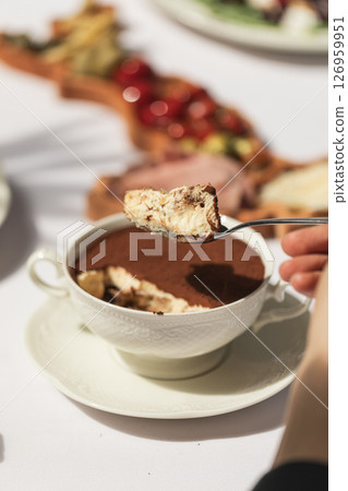 Eating tiramisu dessert in a bowl Eating tiramisu dessert in a bowl 126959951