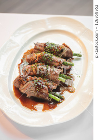 Portion of beef and asparagus rolls appetizer Portion of beef and asparagus rolls appetizer 126959952