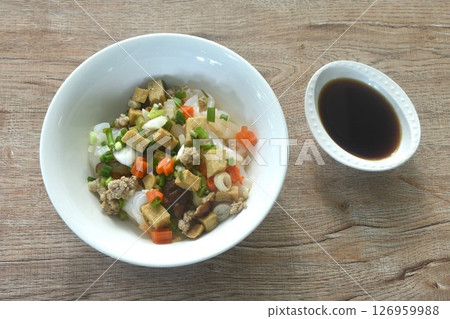 steamed large rice noodles topping chop pork and dice tofu with carrot dressing black soy sauce on plate steamed large rice noodles topping chop pork and dice tofu with carrot dressing black soy sauce on plate 126959988