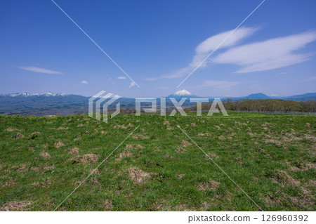 Panoramic views of the snow-capped Niseko mountain range and Mt. Yotei from the ranch Panoramic views of the snow-capped Niseko mountain range and Mt. Yotei from the ranch 126960392