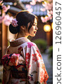 A woman in a kimono looking back and cherry blossoms 126960457