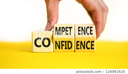 Competence and confidence symbol. Concept word Competence Confidence on wooden cubes. Businessman hand. Beautiful yellow table white background. Business competence confidence concept. Copy space. 126961628