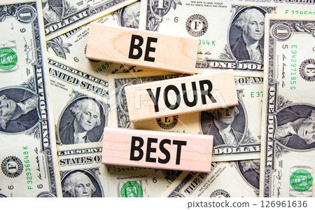 Motivational be your best symbol. Concept words Be your best on beautiful wooden blocks. Dollar bills. Beautiful background from dollar bills. Business motivational be your best concept. Copy space. Motivational be your best symbol. Concept words Be your best on beautiful wooden blocks. Dollar bills. Beautiful background from dollar bills. Business motivational be your best concept. Copy space. 126961636