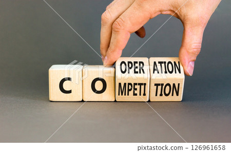 Competition or cooperation symbol. Concept word Competition or Cooperation on wooden cubes. Businessman hand. Beautiful grey background. Business Competition or cooperation concept. Copy space. Competition or cooperation symbol. Concept word Competition or Cooperation on wooden cubes. Businessman hand. Beautiful grey background. Business Competition or cooperation concept. Copy space. 126961658