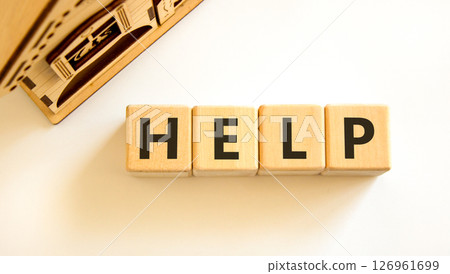 Help symbol. Concept word Help on beautiful wooden blocks. Beautiful wooden house. Beautiful white table white background. Business, lifestyle, support and help concept. Copy space. 126961699