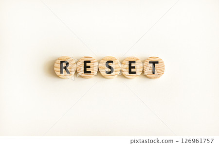 Reset symbol. Concept word Reset on beautiful wooden circles. Beautiful white table white background. Business lifestyle reset concept. Copy space. Reset symbol. Concept word Reset on beautiful wooden circles. Beautiful white table white background. Business lifestyle reset concept. Copy space. 126961757