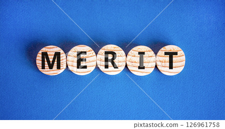 Merit symbol. Concept word Merit on beautiful wooden circles. Beautiful blue table blue background. Business lifestyle merit concept. Copy space. 126961758