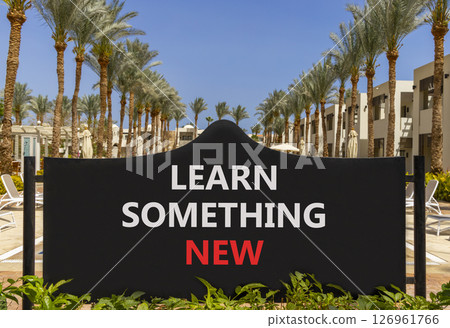 Learn something new symbol. Concept words Learn something new on beautiful black road sign. Beautiful palm tree hotel background. Business motivational lifestyle learn something new concept Copy space Learn something new symbol. Concept words Learn something new on beautiful black road sign. Beautiful palm tree hotel background. Business motivational lifestyle learn something new concept Copy space 126961766
