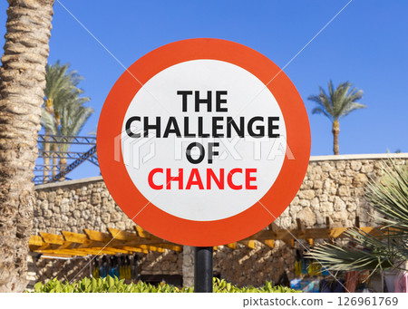 The challenge of chance symbol. Concept words phrase The challenge of chance on beautiful road sign. Beautiful palm tree and blue sky background. Business The challenge of chance concept. Copy space. The challenge of chance symbol. Concept words phrase The challenge of chance on beautiful road sign. Beautiful palm tree and blue sky background. Business The challenge of chance concept. Copy space. 126961769