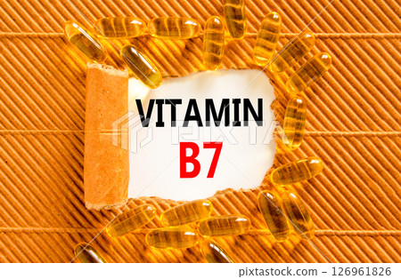 Vitamin B7 biotin symbol. Concept words Vitamin B7 on beautiful white paper. Yellow pills tablets. Beautiful brown background. Medical healthy lifestyle Vitamin B7 concept. 126961826