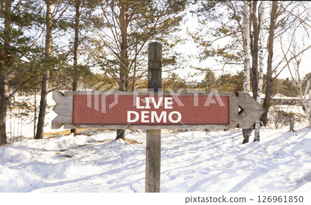 Live demo symbol. Concept words Live demo on beautiful wooden road sign. Beautiful forest snow blue sky background. Copy space. Business and live demo concept. Live demo symbol. Concept words Live demo on beautiful wooden road sign. Beautiful forest snow blue sky background. Copy space. Business and live demo concept. 126961850