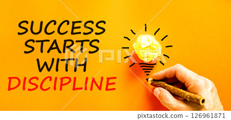 Success starts with discipline symbol. Concept words Success starts with discipline on beautiful orange paper. Beautiful orange background. Business success starts with discipline concept. Copy space 126961871
