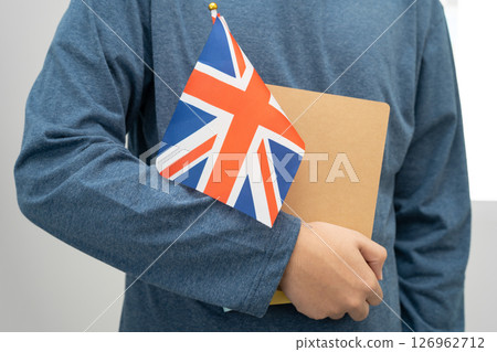 Learn English language, Asian teenage student hold book with flag in course at school. 126962712