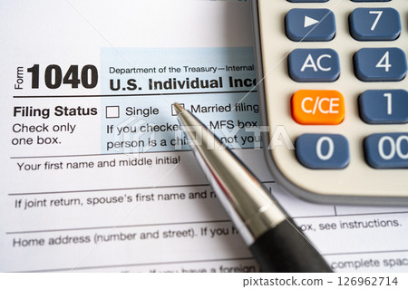 Tax Return form 1040 with pen and calculator, U.S. Individual Income. Tax Return form 1040 with pen and calculator, U.S. Individual Income. 126962714