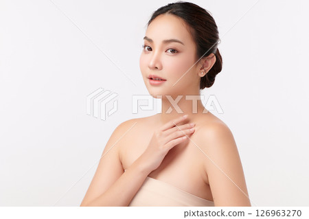 A beautiful young Asian woman with clean, fresh skin against a white background. Skincare, facial treatment, cosmetology, beauty, and spa. An elegant portrait of an Asian woman. A beautiful young Asian woman with clean, fresh skin against a white background. Skincare, facial treatment, cosmetology, beauty, and spa. An elegant portrait of an Asian woman. 126963270
