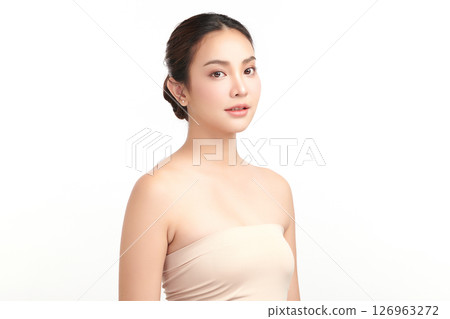A beautiful young Asian woman with clean, fresh skin against a white background. Skincare, facial treatment, cosmetology, beauty, and spa. An elegant portrait of an Asian woman. 126963272