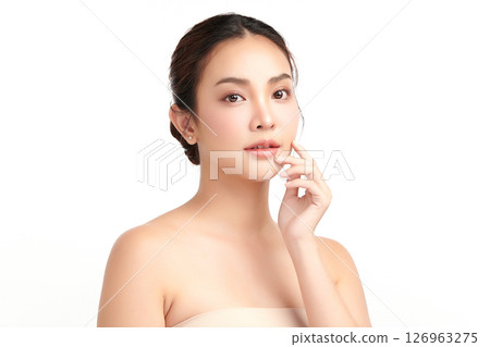 A beautiful young Asian woman with clean, fresh skin against a white background. Skincare, facial treatment, cosmetology, beauty, and spa. An elegant portrait of an Asian woman. A beautiful young Asian woman with clean, fresh skin against a white background. Skincare, facial treatment, cosmetology, beauty, and spa. An elegant portrait of an Asian woman. 126963275