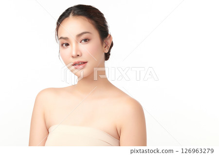 A beautiful young Asian woman with clean, fresh skin against a white background. Skincare, facial treatment, cosmetology, beauty, and spa. An elegant portrait of an Asian woman. 126963279