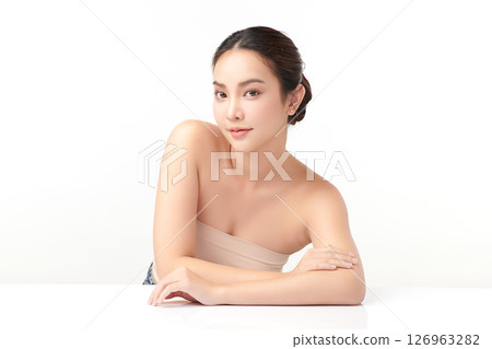 A beautiful young Asian woman with clean, fresh skin against a white background. Skincare, facial treatment, cosmetology, beauty, and spa. An elegant portrait of an Asian woman. 126963282