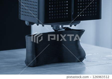 Close up scene the additive manufacturing by 3D printer machine in the light blue scene. 126963512