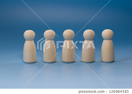 Wooden model doll placed on a blue background. 126964585