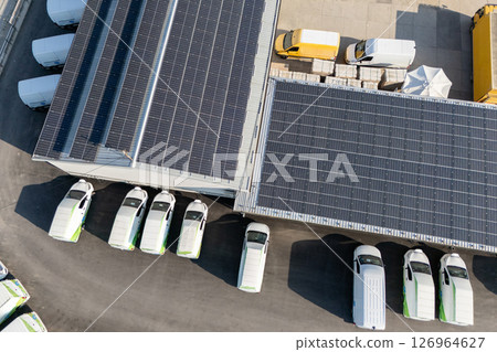 Rows of white electric delivery vans at charging stations for electric vehicles Rows of white electric delivery vans at charging stations for electric vehicles 126964627