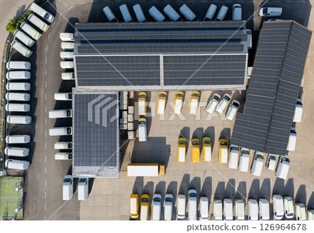 Delivery vans and trucks hub with solar panels on a roof. Fleet of vehicles. 126964678