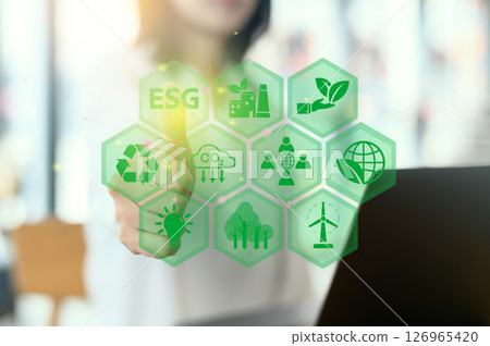 Focused women analyze corporate ESG strategy for sustainable development goals. Business organization uses ESG digital icons for environment social governance investment insights and future growth Focused women analyze corporate ESG strategy for sustainable development goals. Business organization uses ESG digital icons for environment social governance investment insights and future growth 126965420