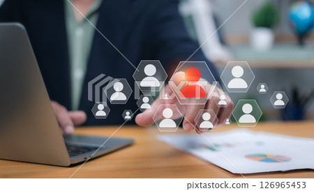 Hand over keyboard with human icons, one red. Symbolizes HR management, leadership, team building, and recruitment. Ideal for human resources, talent acquisition, personnel, and diversity concepts now Hand over keyboard with human icons, one red. Symbolizes HR management, leadership, team building, and recruitment. Ideal for human resources, talent acquisition, personnel, and diversity concepts now 126965453