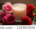 candle featuring floating miniature rose petals, surrounded by vibrant pink and red roses, creating a romantic and luxurious ambiance perfect for relaxation 126965600