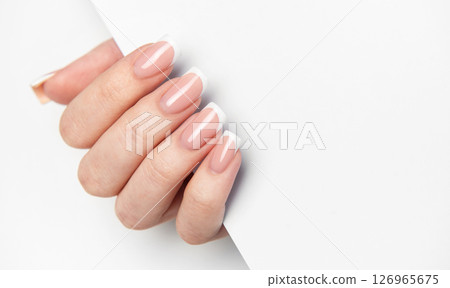 Woman hand showing french manicure on white background 126965675