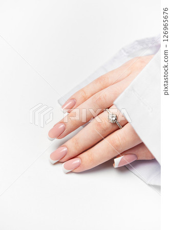 Woman hand showing french manicure and elegant ring on white background Woman hand showing french manicure and elegant ring on white background 126965676