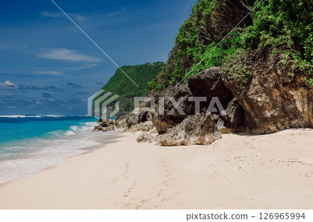 Tropical sandy beach with blue ocean in tropical island Tropical sandy beach with blue ocean in tropical island 126965994
