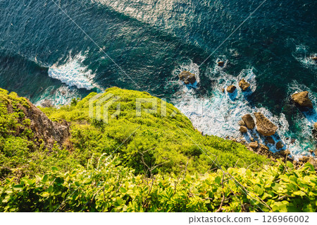 Ocean with waves crashing on rocks stones, view from high rocky coastline Ocean with waves crashing on rocks stones, view from high rocky coastline 126966002