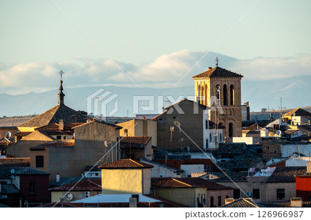 A captivating view of Toledo, Spain, with its iconic buildings and architecture silhouetted against the skyline. 126966987