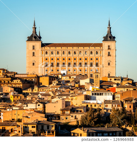 The majestic Alcazar of Toledo stands tall against a clear blue sky, showcasing its architectural grandeur. 126966988