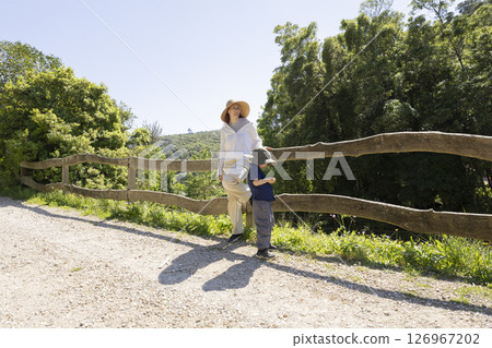 Mother and son enjoying scenic view on hiking trail Mother and son enjoying scenic view on hiking trail 126967202