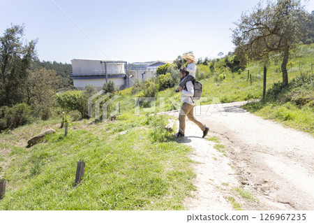 Father and daughter enjoying a walk in the countryside near a water purification facility Father and daughter enjoying a walk in the countryside near a water purification facility 126967235