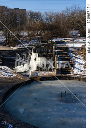 Frozen fountain and waterfall. Morning of frosty February Frozen fountain and waterfall. Morning of frosty February 126967454