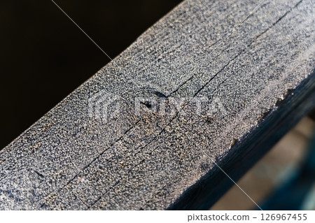 Frost on wooden railings, fences. Frost. Macro. Diagonal lines Frost on wooden railings, fences. Frost. Macro. Diagonal lines 126967455