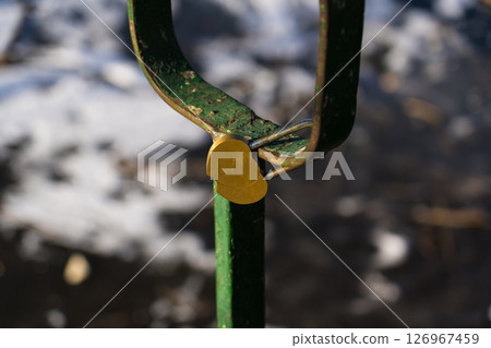 Iron, old handrails with a lock on them. Love lock on the railing Iron, old handrails with a lock on them. Love lock on the railing 126967459