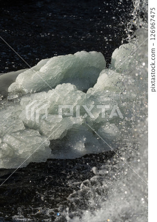 Frozen waterfall. Huge chunks of ice. Blocks of ice in the waterfall 126967475