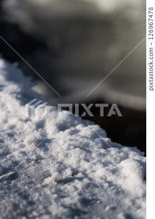 Frost on concrete. Snow from the waterfall. Frozen water Frost on concrete. Snow from the waterfall. Frozen water 126967478