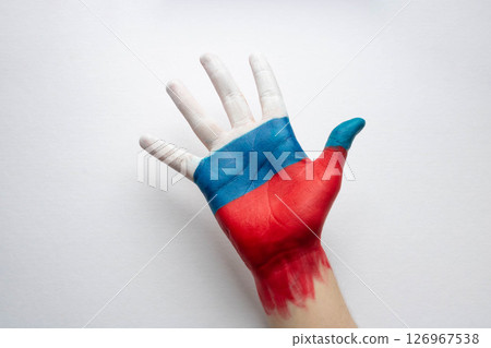 For Russia Day, an open palm, painted in the colors of the Russian flag. The concept of peace friendship and creation For Russia Day, an open palm, painted in the colors of the Russian flag. The concept of peace friendship and creation 126967538