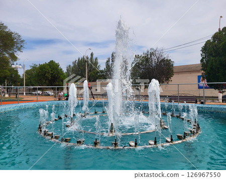 Russia Kerch 14 09 2024 Jets of water from the fountain scatter in the air. Water splashes from the fountain in the park. The vertical jets of the fountain are beating in the city park. Russia Kerch 14 09 2024 Jets of water from the fountain scatter in the air. Water splashes from the fountain in the park. The vertical jets of the fountain are beating in the city park. 126967550